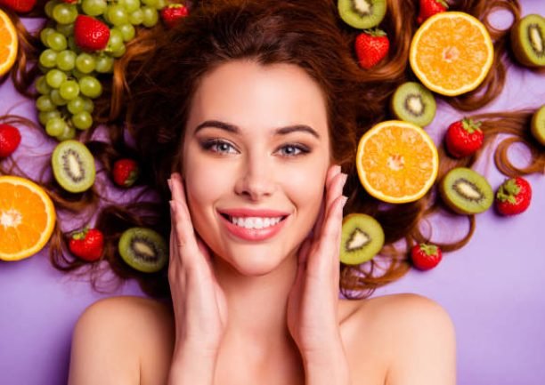 Close-up cropped portrait of nice attractive lovely well-groomed pure perfect, shine cheerful cheery feminine wavy-haired lady touching smooth clean clear skin isolated over violet purple background